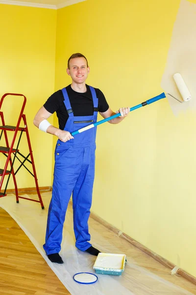 A young man makes repairs to the apartment, ok re-paints the walls in a different color