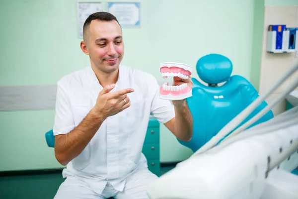 Positive Doctor White Uniform Showing Mock Jaw Teeth While Sitting — Stock Photo, Image