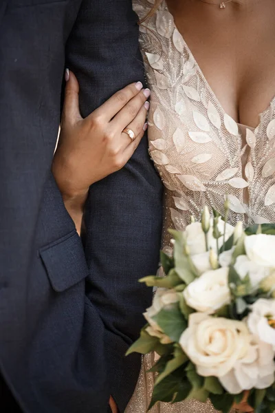 Wedding bouquet with fresh natural flowers in the hands of the bride