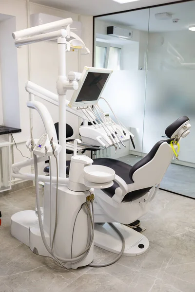 A modern dental office with new equipment and a dental chair. Cabinet for dental treatment. High quality photo