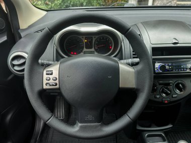 Direksiyon, güneş ışığı arabaya girerken dikkat edilmesini emreder. Gösterge paneli göstergeleri şehir yaşamını yansıtıyor, hareketli sokaklarda bekleyen maceraları ima ediyor.