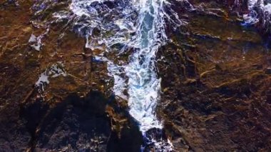 Gün batımı, dalgaların kayalık kıyıya çarpmasıyla gökyüzünü ılık renklerle boyar. Su ve toprağın karışımı doğanın ham gücünü ön plana çıkaran çarpıcı bir manzara yaratır..