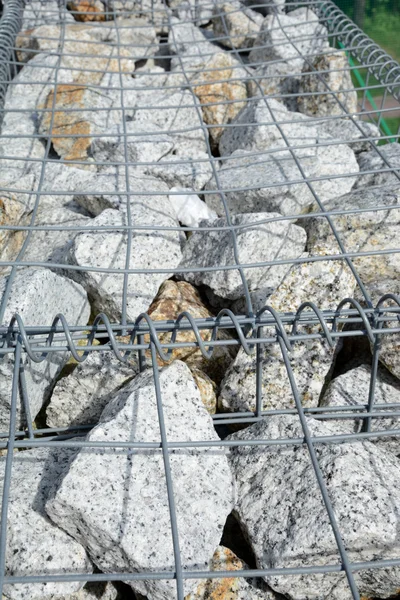 Stones in wire net — Stock Photo, Image