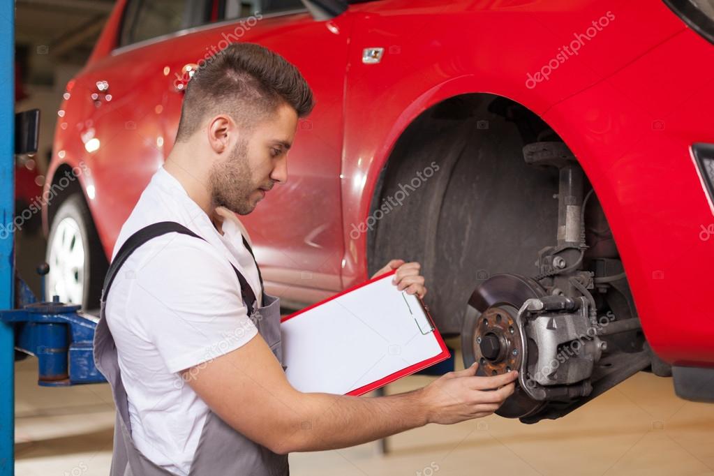Checking a car brakes — Stock Photo © studioloco 66830779