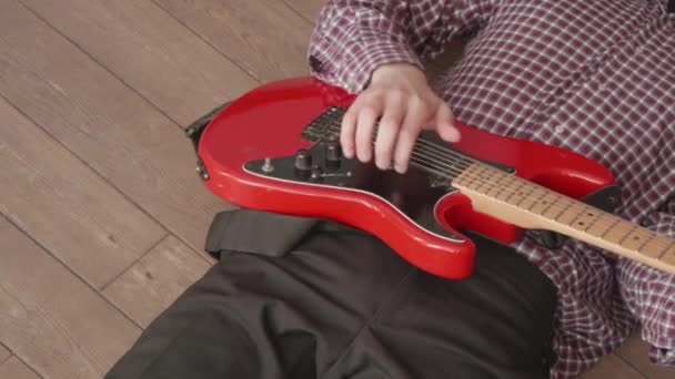 Man Rutig Skjorta Spelar Röd Elgitarr Som Ligger Strandpromenaden — Stockvideo