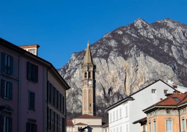 View of the bell tower of Lecco from an alley of the town