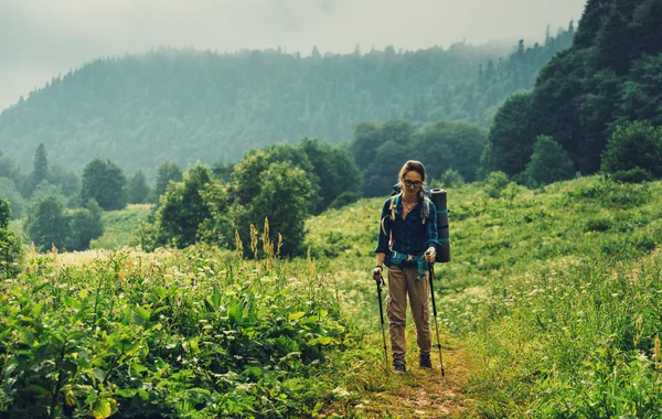 Женщина-туристка, гуляющая в горах — стоковое фото