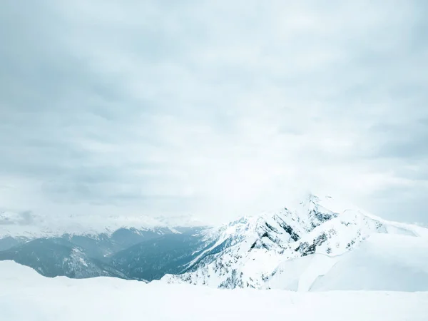 Snow-capped mountain peaks. Epic mountain landscape and dramatic sky.