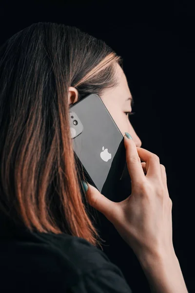 2021年3月24日 ロシアのゲレンシュク 若い女性はIphone 11で話しています Appleロゴはカメラに展開されます — ストック写真