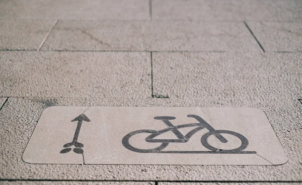 Sign of a bicycle path on the sidewalk.