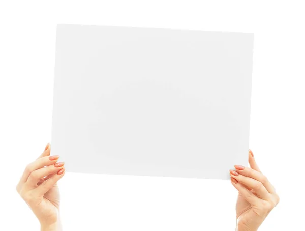 Female hands gracefully hold a blank poster for a mockup on a white background. — Stock Photo, Image