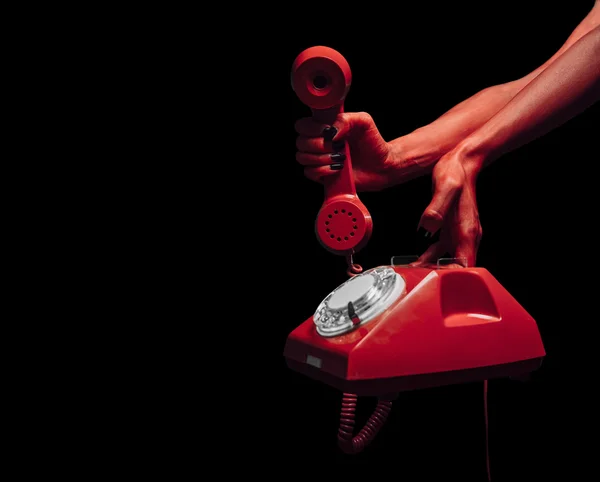 Devil hands with retro phone — Stock Photo, Image