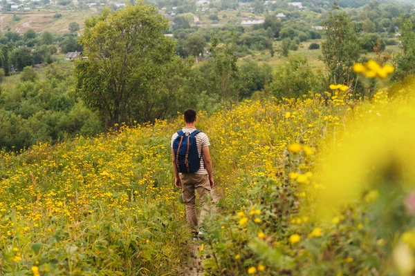 Man walking on flower meadow — Stock Photo, Image