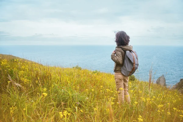 Hiker woman looks on the sea — Stock Photo, Image