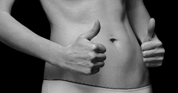 Female slim abdomen with thumbs up — Stock Photo, Image