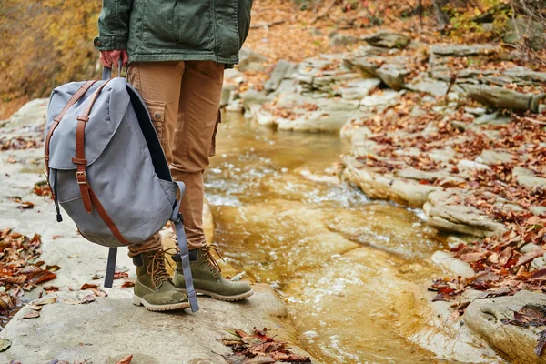 female hiker with backpack near river