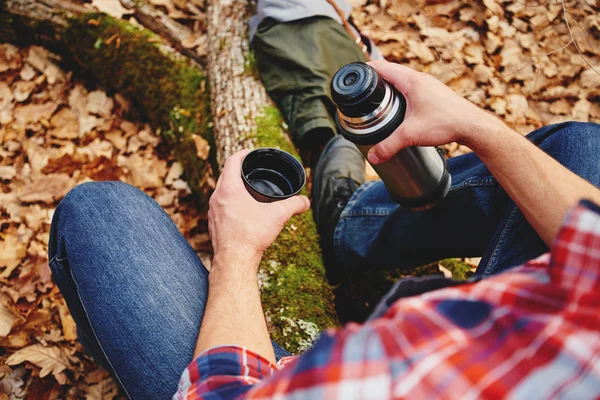 Man with cup of tea and thermos — Stock Photo, Image