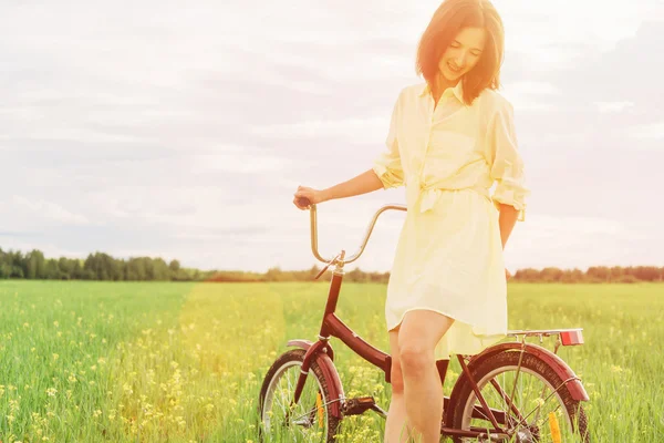 Woman walking with bicycle — Stock Photo, Image