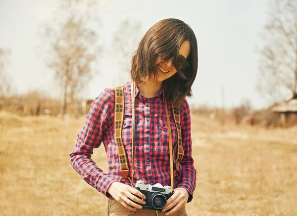 Woman holding vintage photo camera — Stock Photo, Image