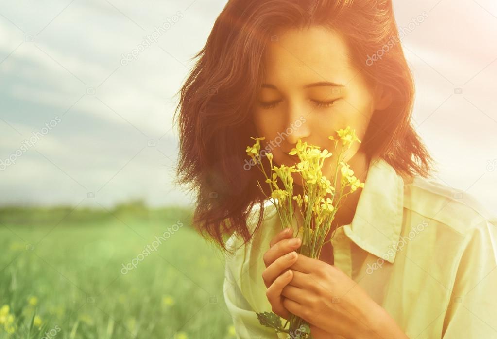 Woman smelling flowers in summer