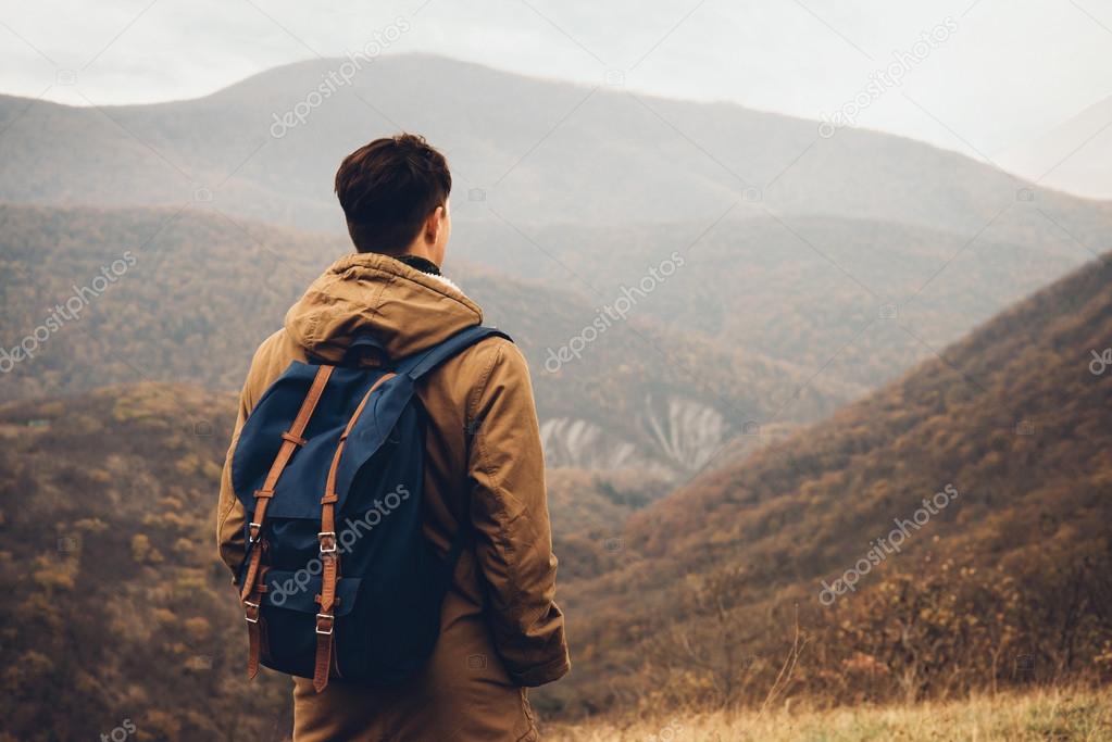 Man with backpack on hill