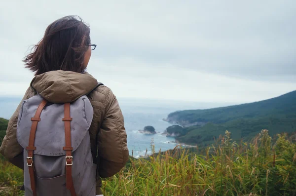 Mujer excursionista mirando a la distancia a la isla —  Fotos de Stock