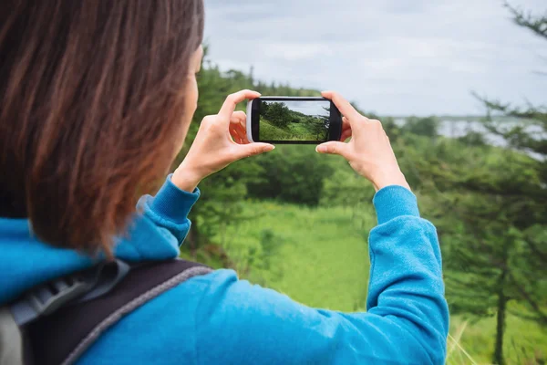 Woman taking photographs of summer landscape — Stock Photo, Image