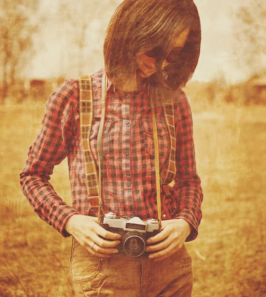 Woman holding vintage photo camera — Stock Photo, Image