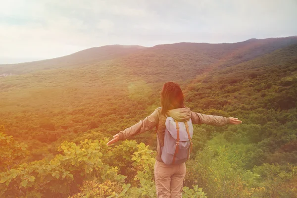 Woman standing with raised arms on mountain — Stock Photo, Image