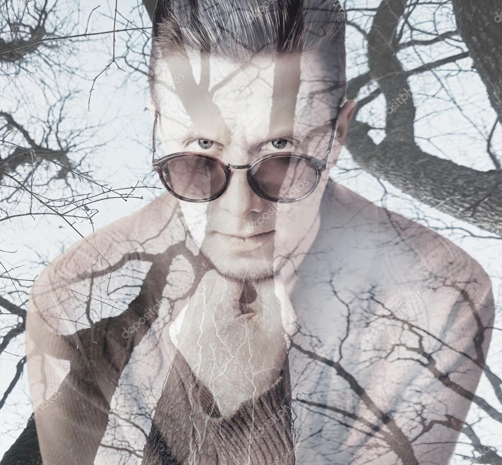 Double exposure portrait of man with trees