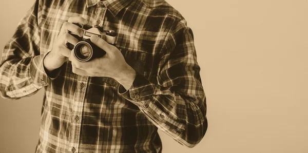 Young man with old photo camera — Stock Photo, Image