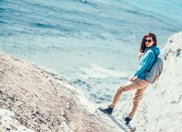 Beautiful young woman standing on coast — Stock Photo, Image