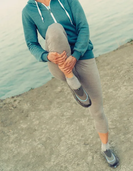 Woman stretching her legs before running — Stock Photo, Image
