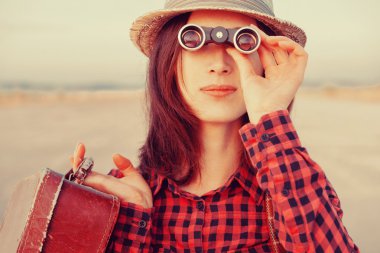 traveler woman looking through binoculars