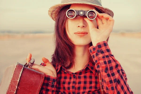 Traveler woman looking through binoculars — Stok fotoğraf