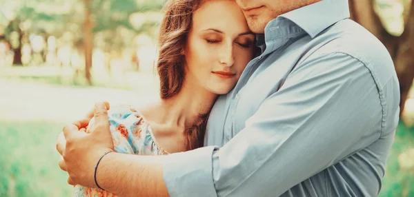 Man embracing woman with closed eyes — Stock Photo, Image