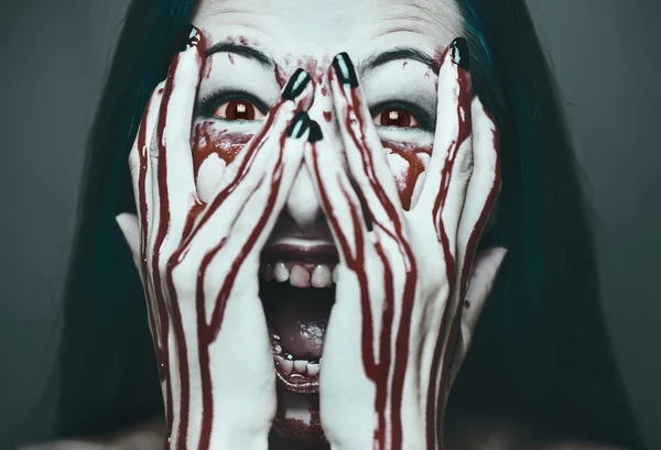 Spooky woman with face and hands in blood — Stock Photo, Image