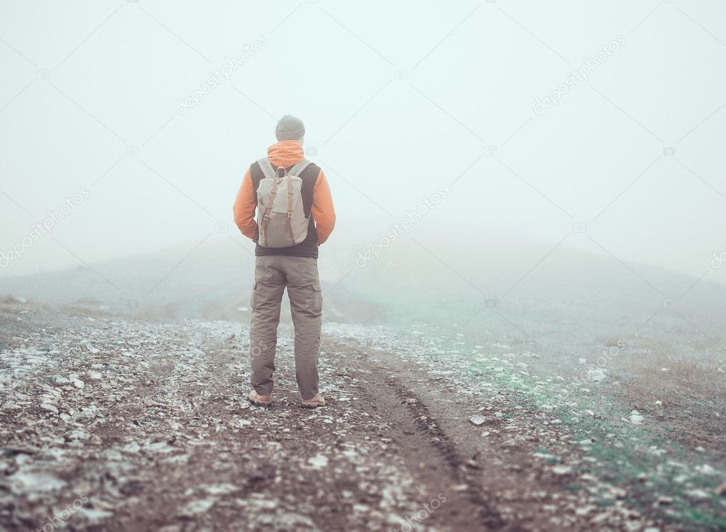 Hiker standing on road 