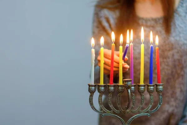 Židovská žena osvětlení Chanuka svíčky v menorah. — Stock fotografie
