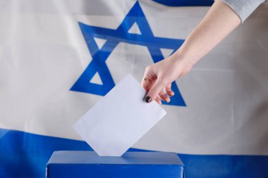 Israeli woman votes at a polling station on election day. clipart