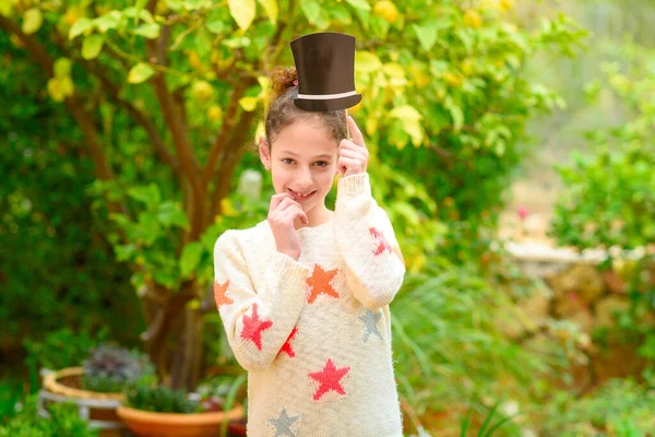 Cheerful Little Girl with hat on stick. Outdoor celebration, Purim, Fool day, birthday party concept. — Stock Photo, Image