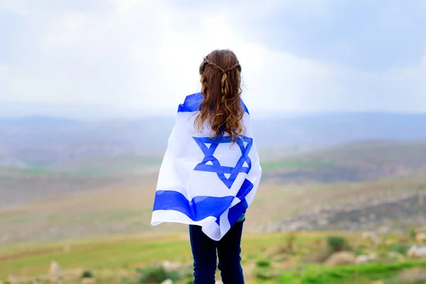 Ізраїльська дівчинка з ізраїльським прапором.. Ліцензійні Стокові Зображення
