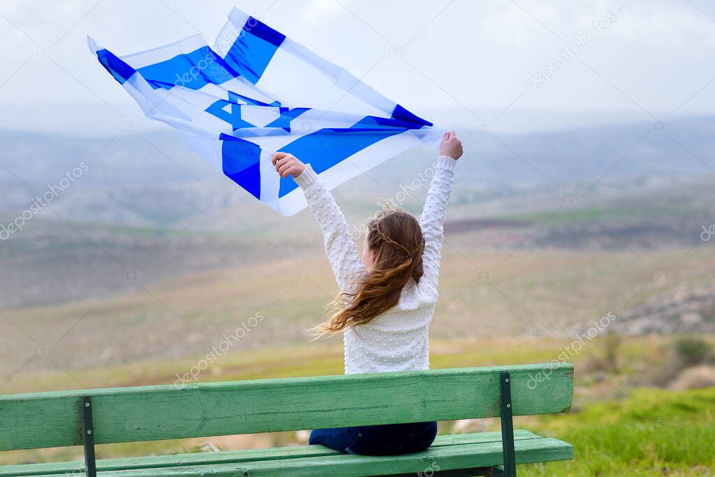 Israeli jewish little girl with Israel flag back view.