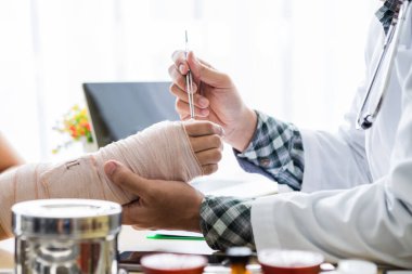 Doktor bey, kadın hasta elinin kolunu sabitleyin. Kolu kırıktır. İyileşmek için tekerlekli sandalyede oturun..