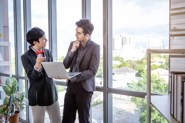 Company executive Young Asian businessman and coaching personal secretary assistant Homosexual businessman LGBT  partners while working together with laptop computer and strategy in business in office