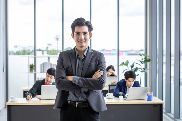 Successful company,executive Young Asian businessman partners with happy workers Group of asian business people with diverse genders (LGBT) in the meeting room at office