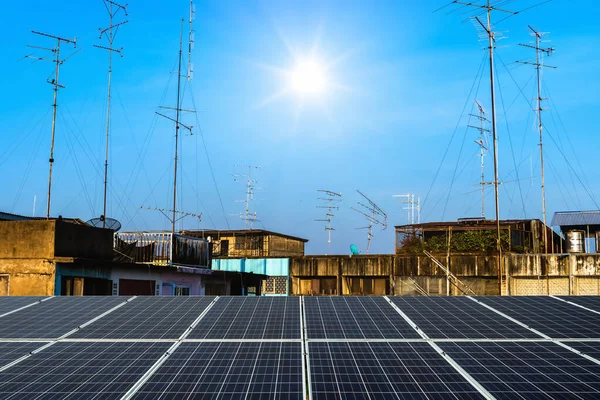 Photovoltaic modules solar power plant with Antenna and satellite on the roof with the house or building in Country town city construction in provincial area in blue sky with cloud Background