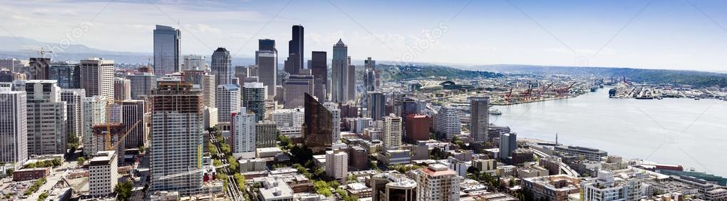 Beautiful aerial view of Seattle Washington's downtown skyline from the top of the Space Needle. This photo shows the business development, sports stadiums, new construction, and heavy industrial side of Seattle, especially with the Port of Seattle