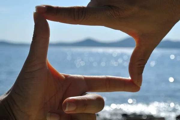 View finder from hands with sea view — Stock Photo, Image