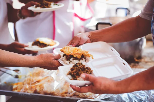 Volunteers Share Food to the Poor to Relieve Hunger: Charity food concept